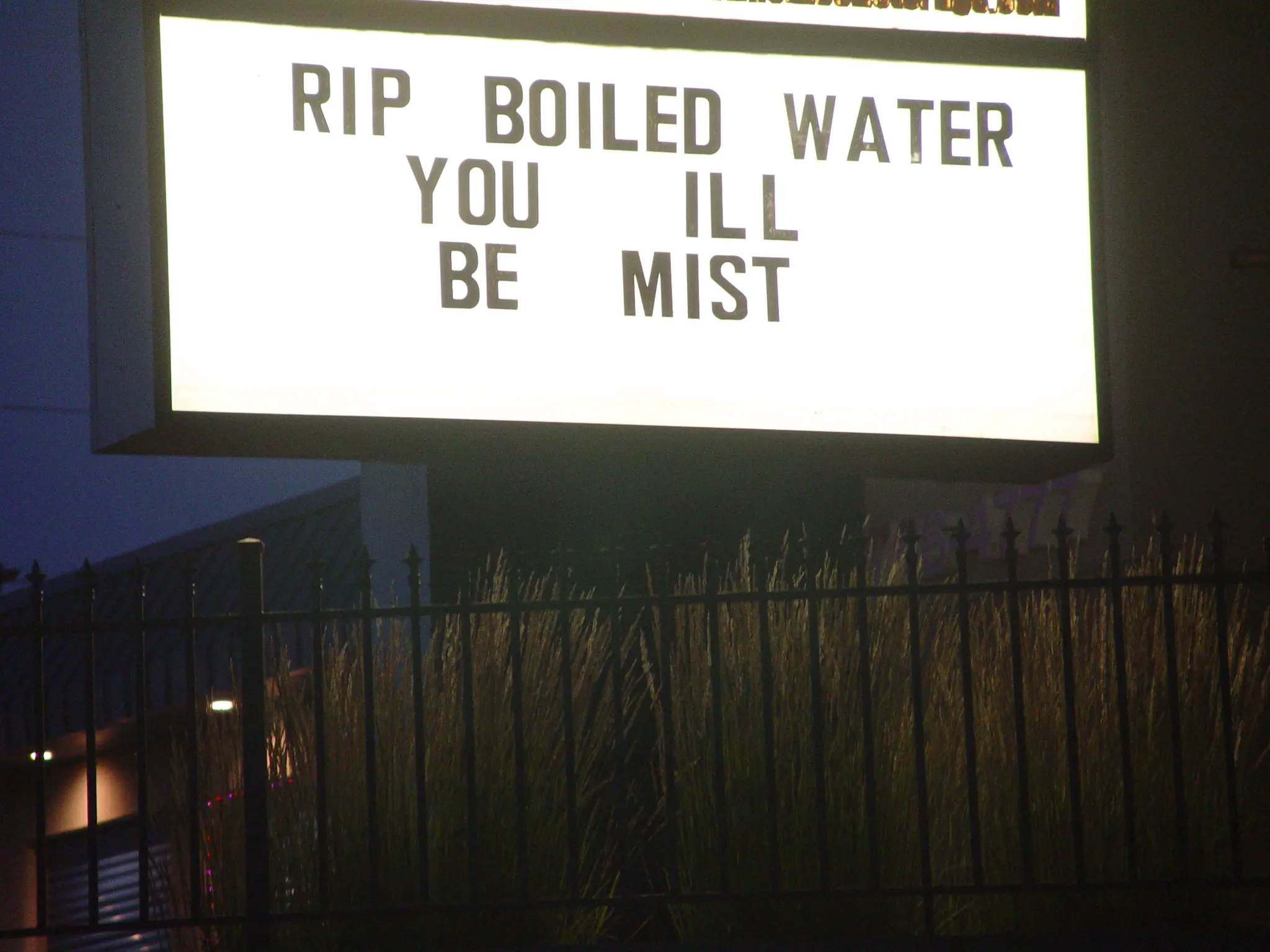 lit up sign saying "RIP BOILED WATER YOU ILL BE MIST"