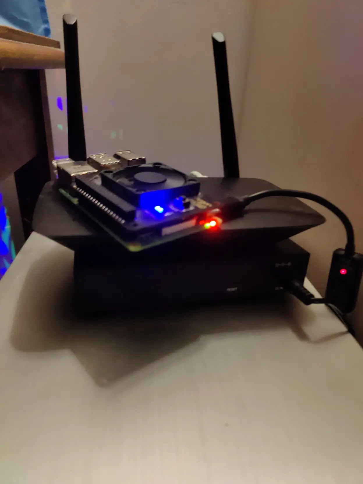 a raspberry pi on top of a shitty router on top of a network switch on top of a full tower pc( server)