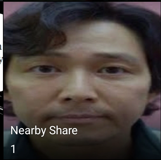 photo album titled "nearby share" with a photo of Seung Gi-hun from squid games getting his photo taken